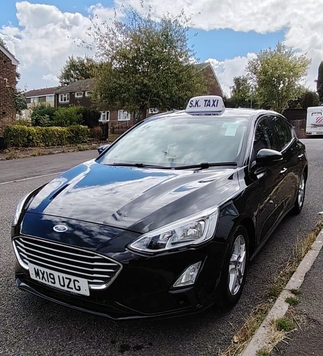 The licensed S K Taxis Ford Focus, clean and ready for a journey in Frome.